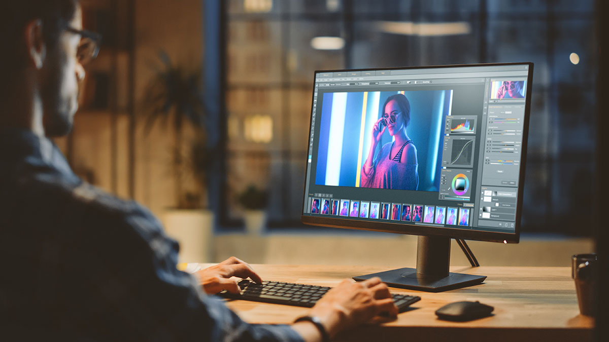 man adjusting a monitor